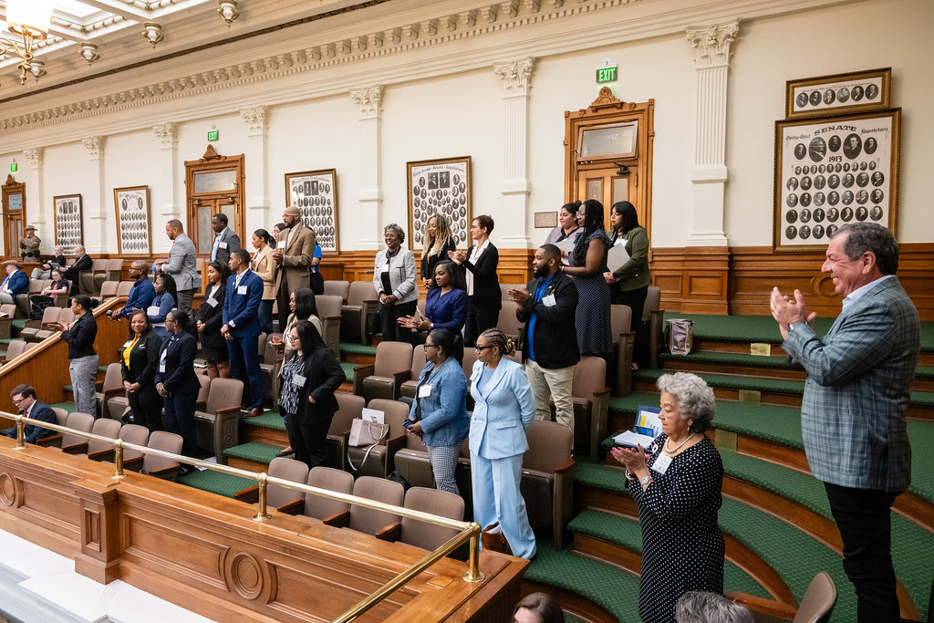 People standing and clapping